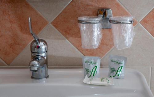 a sink with two cups and a faucet at Hotel Agata in Biella