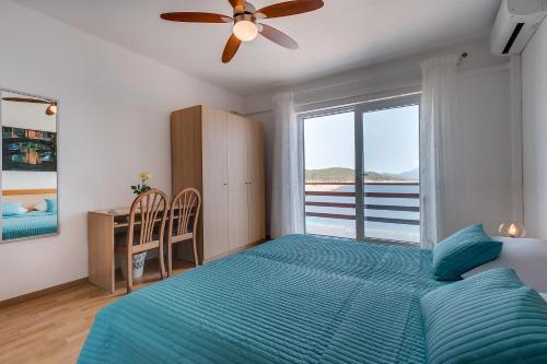 a bedroom with a bed and a large window at Apartment Marika in Mali Lošinj