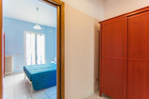 a mirror in a room with a bed and a dresser at Residence Kimba in Rimini