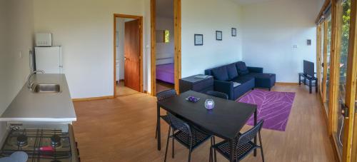 a living room with a table and a couch at Intact Farm Resort in Velas