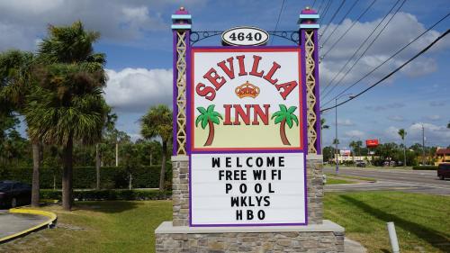 a sign for aulum inn on a street at Sevilla Inn Kissimmee- Near Disney in Kissimmee