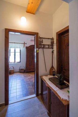 a kitchen with a sink and a door to a room at Apartments Lena in Komiža