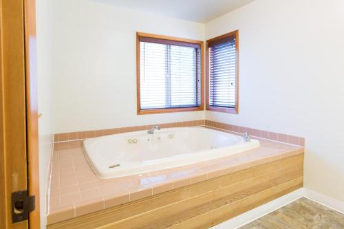 a bathroom with a tub and a window at Westcliff Lodge in Hood River