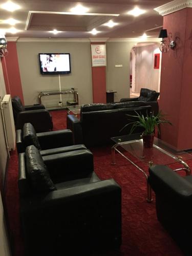 a waiting room with couches and a flat screen tv at Minabir Otel in Ankara
