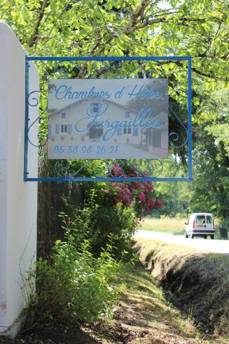 a sign for a house on the side of a road at Chambre d'Hôtes au Sargaillon in Pouillon