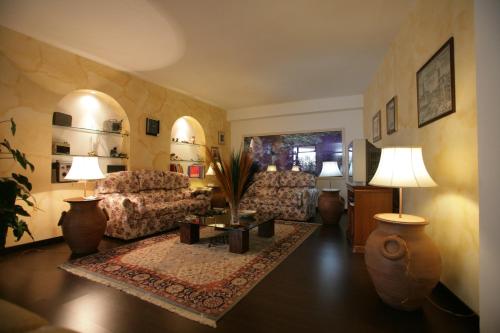 a living room with two couches and a table at Bed And Breakfast casagalez in Santa Domenica