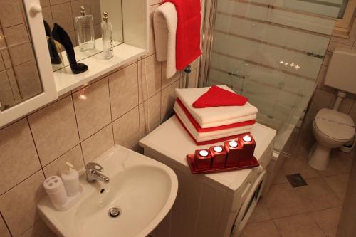 a bathroom with a sink and a toilet and towels at Apartments Z in Dugi Rat