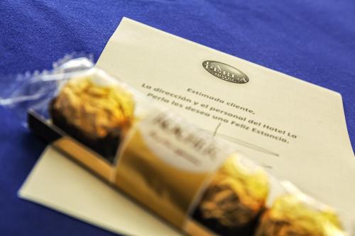 a card with a packet of food on a table at La Perla in Almería