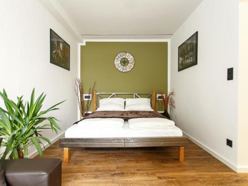 a bedroom with a bed and a clock on the wall at Ferienwohnung Tiergarten in Berlin
