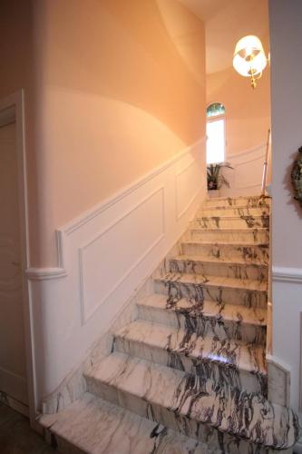 a set of stairs in a home with a rug at Il Giardino delle Jacaranda in Talsano