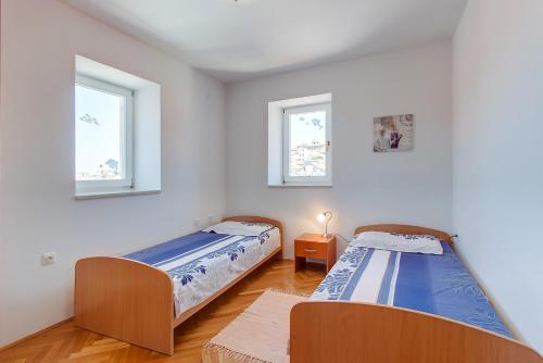 Posteľ alebo postele v izbe v ubytovaní Apartments Bellus Mare