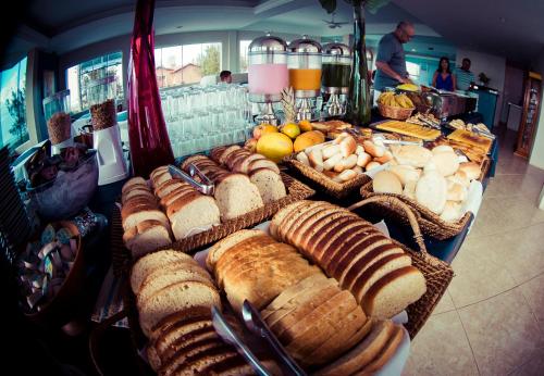a display of bread and pastries on a table at De Rose Praia Hotel in Torres