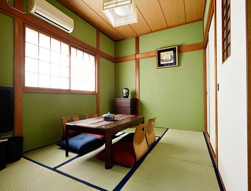 a dining room with a wooden table and chairs at City Hotel Universal Studios Japan in Osaka