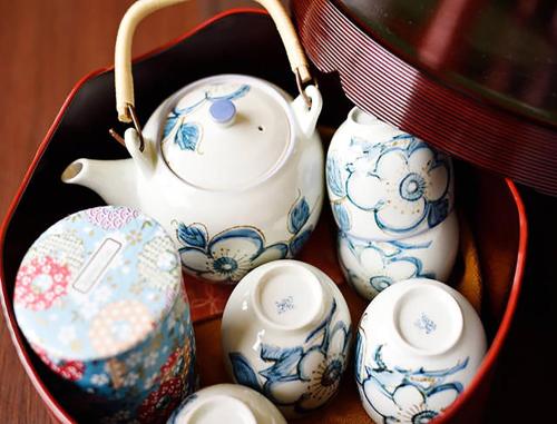 a group of teapots and cups in a container at CITY HOTEL Nishikujo Residence 1 in Osaka