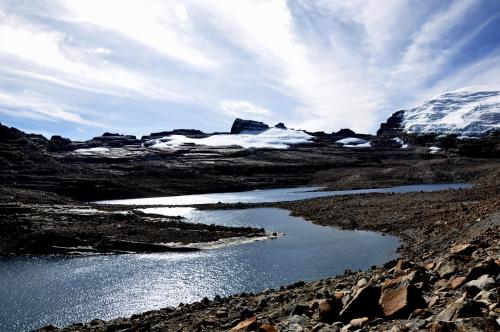 a body of water in a field with snow at Hotel Brisas del Nevado in Güicán