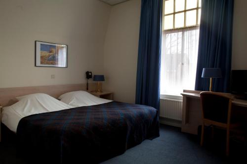 Ένα ή περισσότερα κρεβάτια σε δωμάτιο στο 't Witte Hoes