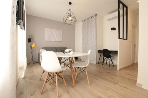 une salle à manger avec une table et des chaises blanches dans l'établissement Cosy-Cocoon, à Cannes
