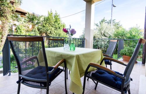a table with a green table cloth on a patio at Apartments Lanča in Opatija
