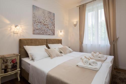a bedroom with two beds with towels on them at Luxury Apartment Luce in Split