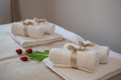 two towels with bows and flowers on a bed at Luxury Apartment Luce in Split