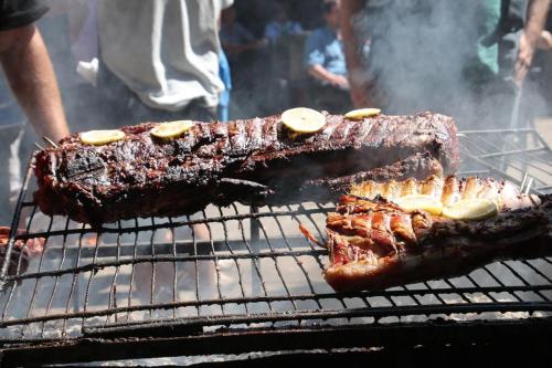 two pieces of meat cooking on a grill at La Casa De Lily in Buenos Aires