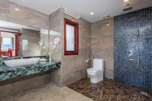 a bathroom with a sink and a toilet and a shower at Apus Hotel in Nha Trang