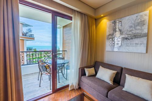 a living room with a couch and a balcony at Dream Land Oasis in Chakvi