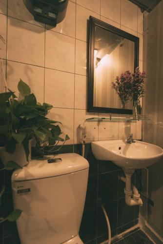 a bathroom with a toilet and a sink at The Like Hostel & Cafe in Ho Chi Minh City