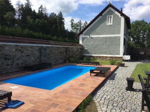 a swimming pool in the backyard of a house at Chalupa Volárna in Roudno