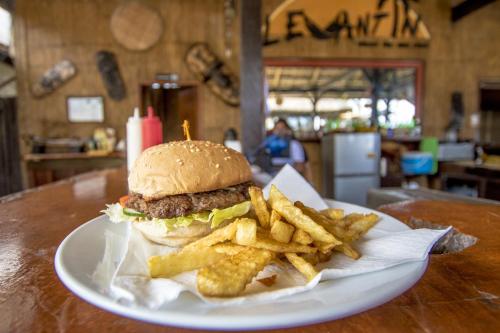 a hamburger and french fries on a plate on a table at Levantin Boracay in Boracay