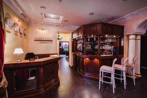 a bar with two chairs and a counter in a room at Boutique Hotel Renaissance in Murmansk