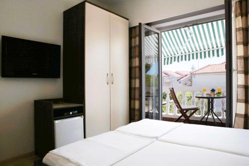 Ένα ή περισσότερα κρεβάτια σε δωμάτιο στο Apartments and Rooms Bozena