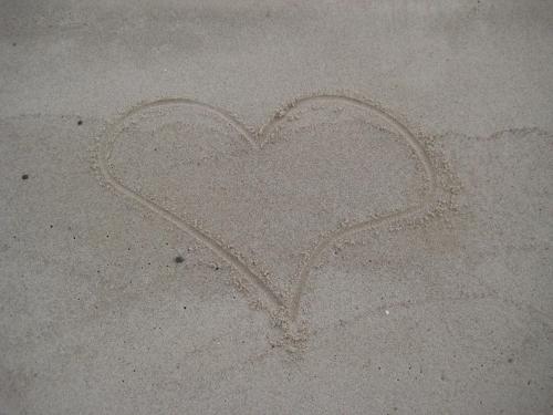 a heart drawn in the sand on the beach at Wisełka PERŁA Bałtyku in Wisełka