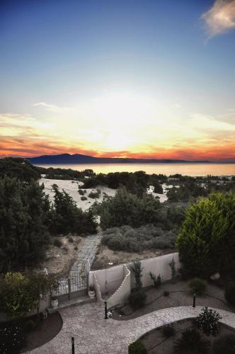 a view of a sunset over the water at Villa Alyko in Aliko Beach
