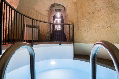 a bath tub sitting on top of a balcony at La Falconeria Hotel in Valletta