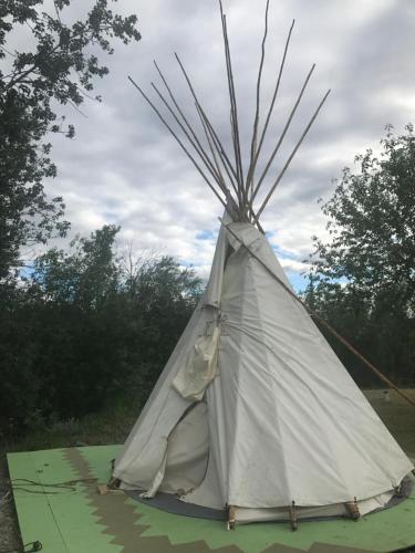 a teepee with sticks sticking out of it at Klutina Kate's B&B in Copper Center