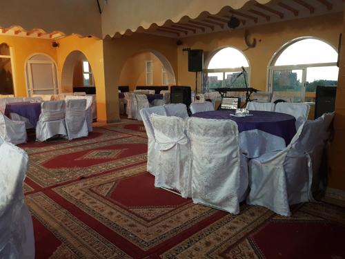 a room with tables and chairs in a room with ceilings at Atlas Resorts in Aït Ourir
