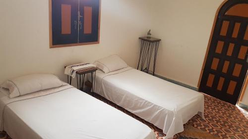 a room with two beds in a room at Atlas Resorts in Aït Ourir