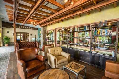 a restaurant with leather chairs and tables and shelves at Dream Land Oasis in Chakvi