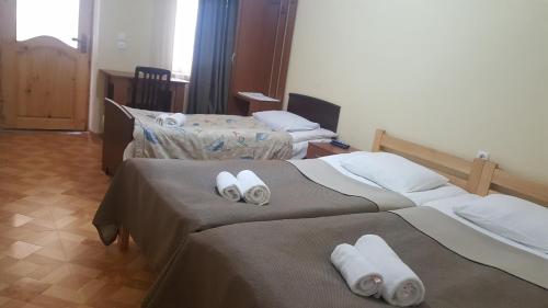 two beds in a hotel room with towels on them at Mestia 4 season in Mestia