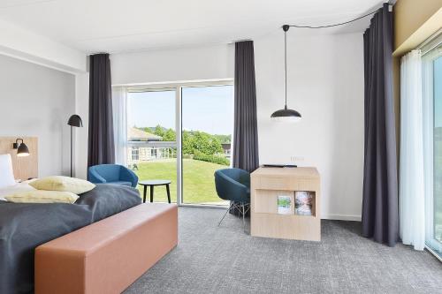 a bedroom with a bed and a large window at Best Western Plus Hotel Fredericia in Fredericia