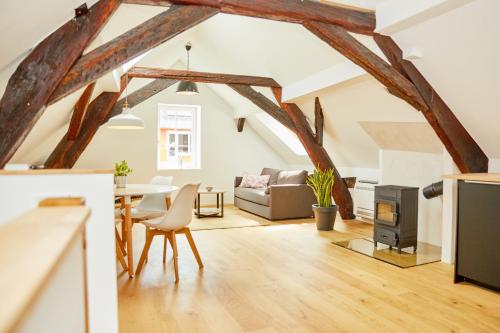 a living room with a table and a fireplace at Zehn in Bernkastel-Kues