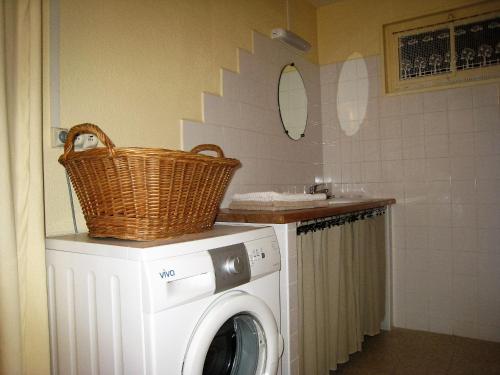a washing machine with a basket on top of it at Gite du Boulidou in Cazilhac