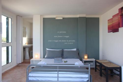 a bedroom with a bed with a sign on the wall at Villa Giulia&Gaia - Guest House in Nardò