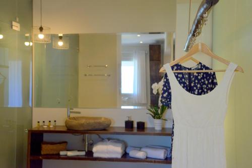 a dress hanging in a bathroom with a mirror at Panorama Hotel in Klima