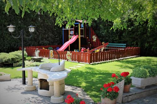 a park with a playground with a slide at Halász Airport Panzio in Vecsés