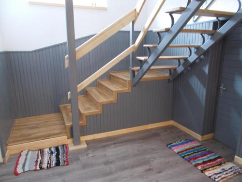 a staircase in a room with a rug at Kristály Vendégház in Bogács