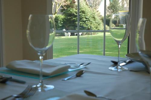 a table with two wine glasses on top of it at Lubnaig Guest House in Callander