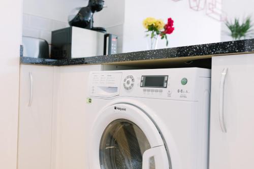 a white washer and dryer in a kitchen at Sea View Sanctuary Apartment! in Margate