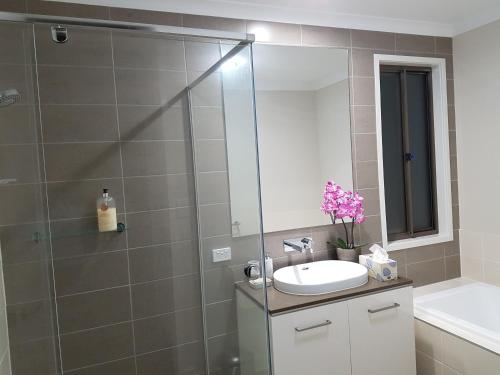 a bathroom with a sink and a shower at Jasper Place in Brisbane